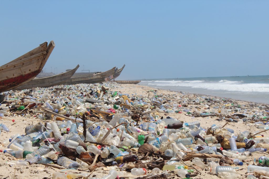 Plastic waste accumulates along Ghana’s coastline, where ocean currents and urban runoff carry discarded bags and bottles to the shore. Image Credit: GlobalIssues.org.