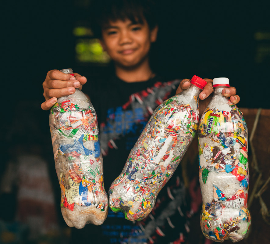 A student in Bontoc, Northern Philippines proudly holds his Ecobricks. Image Credit: Josephine Chan and Ian Christie, Wiki Commons. A student in Bontoc, Northern Philippines proudly holds his Ecobricks. Image Credit: Josephine Chan and Ian Christie, Wiki Commons.