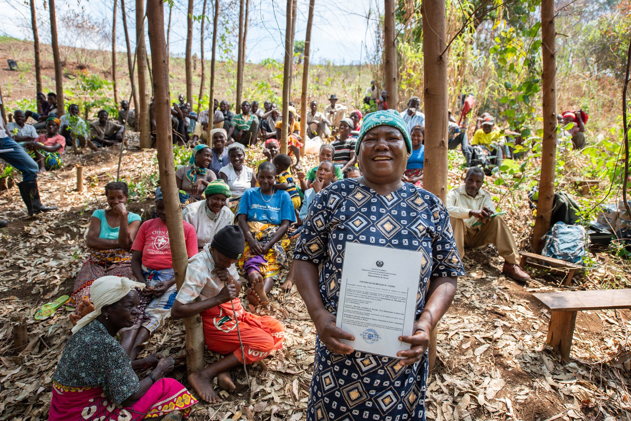 Queen Adelina of Mucunha holding the legal deed that recognizes the ownership of Namuli’s land by the Lomwe people. This is a historical achievement in a region with a legacy of colonial occupation and displacement of community in favor of external enterprises. As part of the process of land delimitation, 70% of the household lands have been titled to women reinforcing their central role in Lomwe culture and politics. Photo by Roshni Lodhia/Legado Queen Adelina of Mucunha holding the legal deed that recognizes the ownership of Namuli’s land by the Lomwe people. This is a historical achievement in a region with a legacy of colonial occupation and displacement of community in favor of external enterprises. As part of the process of land delimitation, 70% of the household lands have been titled to women reinforcing their central role in Lomwe culture and politics. Photo by Roshni Lodhia/Legado