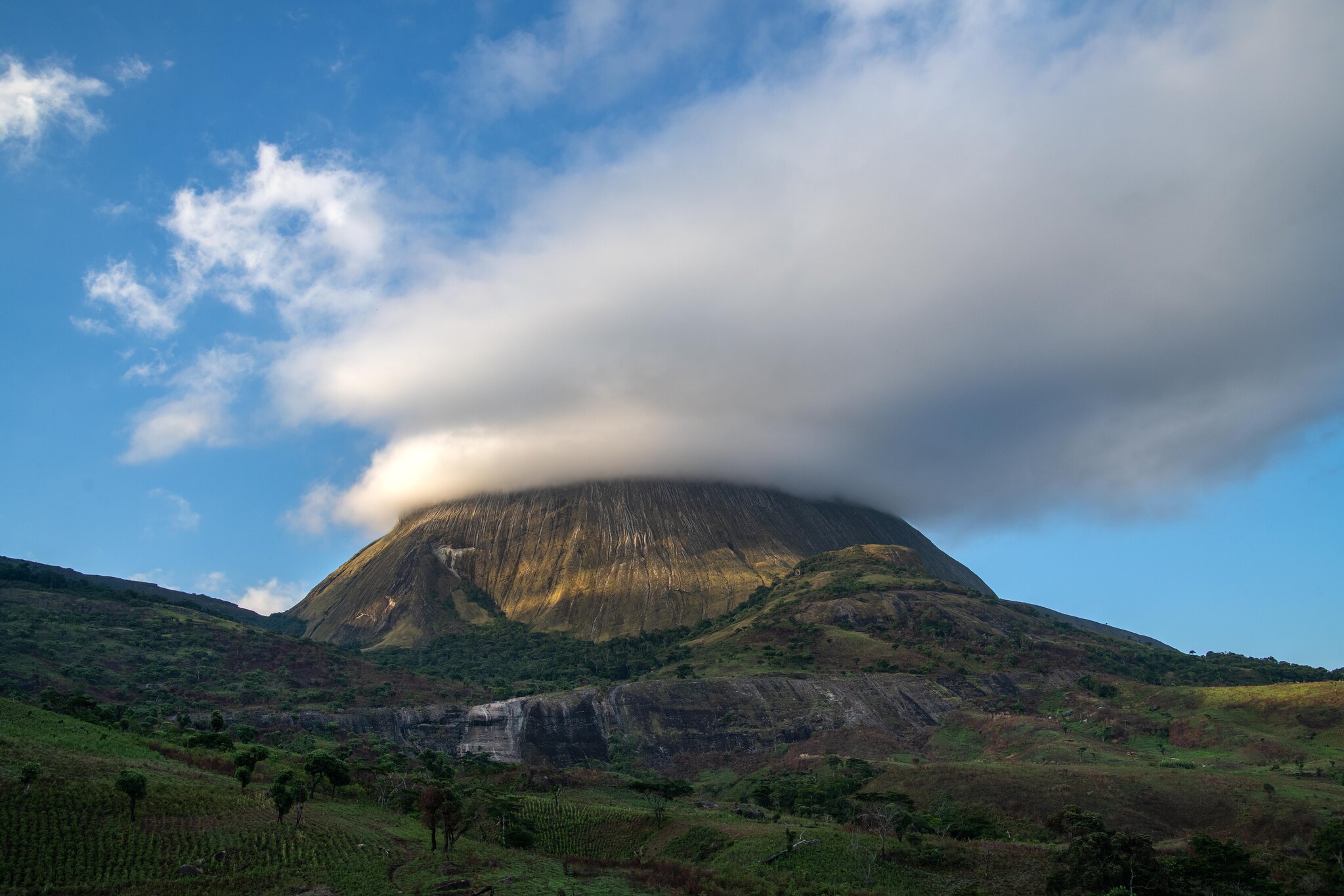 The Namuli mountain range captures rain clouds and creates perfect conditions for its communities to farm almost all year round. Photo by Roshni Lodhia/Legado The Namuli mountain range captures rain clouds and creates perfect conditions for its communities to farm almost all year round. Photo by Roshni Lodhia/Legado